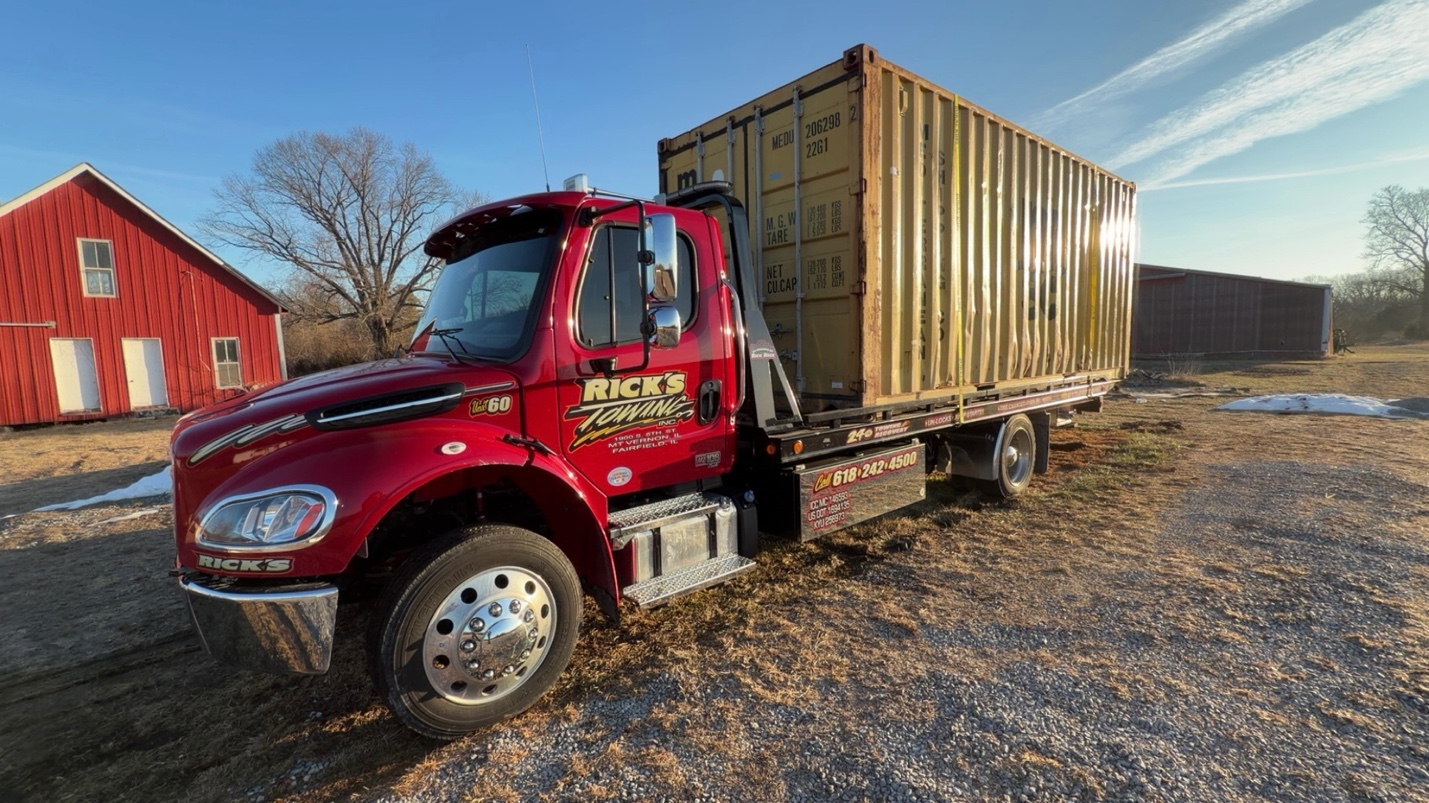 Rick's Towing flatbed hauling shipping container