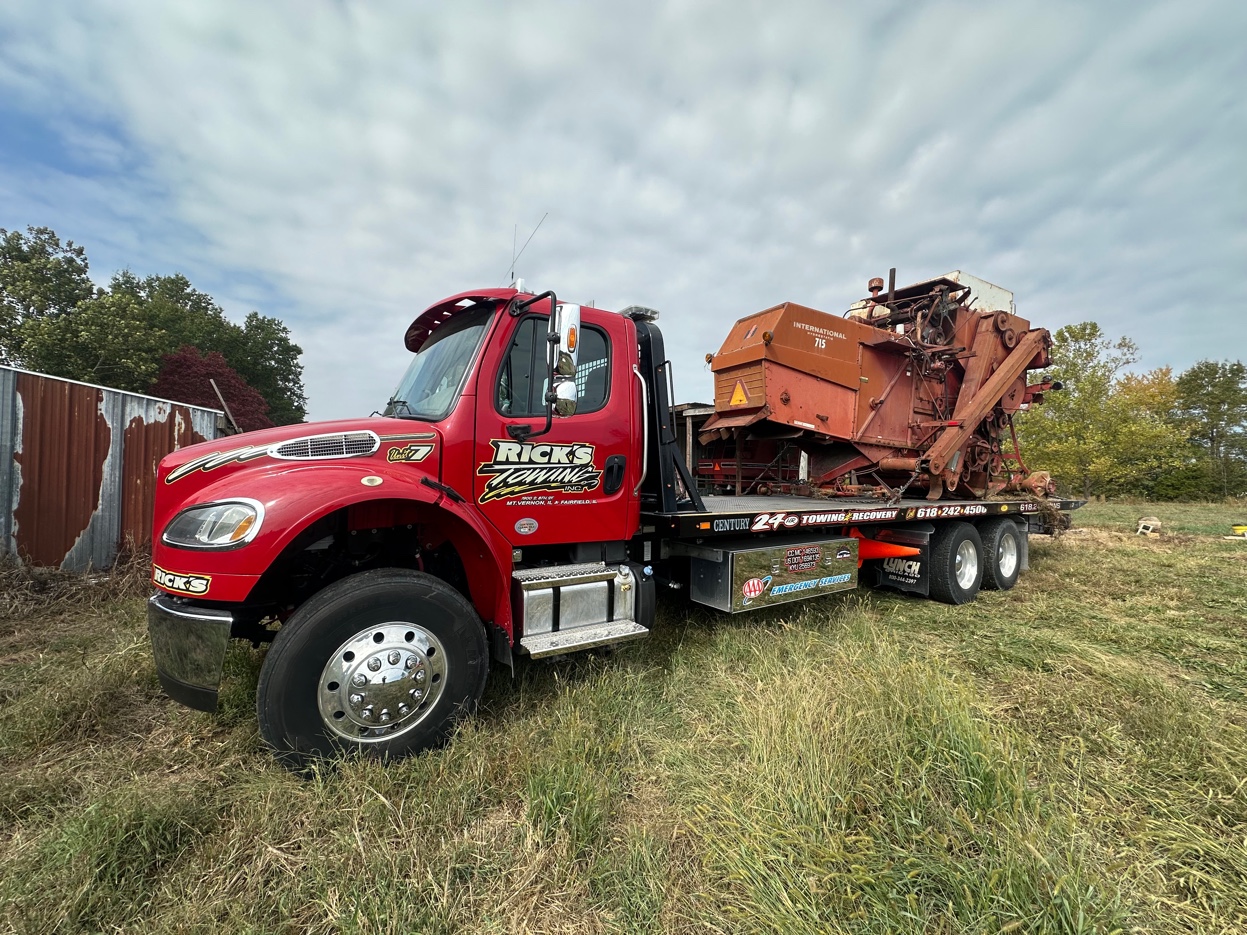 Rick's Towing hauling farm equipment on flatbed — Southern Illinois