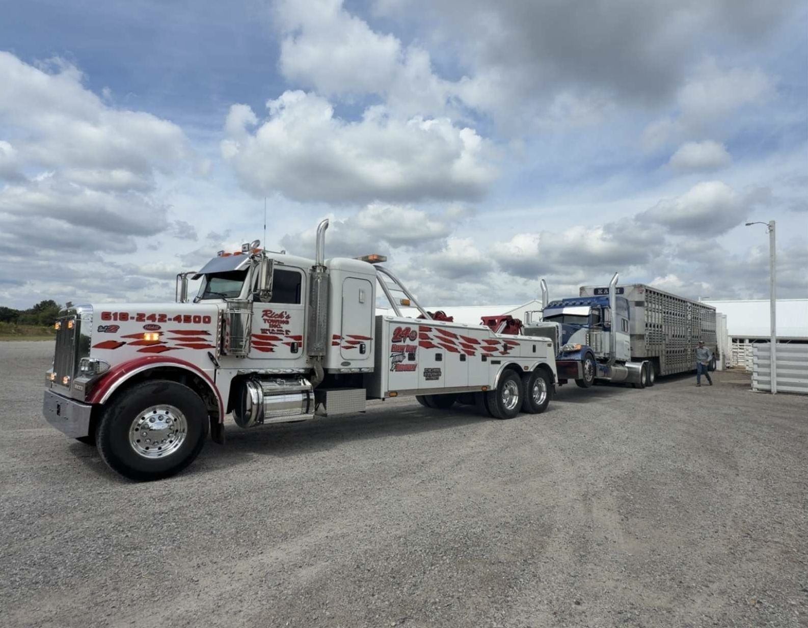 Rick's Towing Unit 2 heavy wrecker towing a livestock semi tractor-trailer